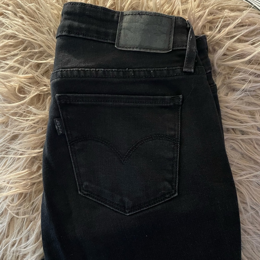 Levi’s black distressed jeans.